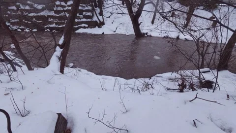 Rain and snow creating strong river flow in winter Stock Footage 324548154