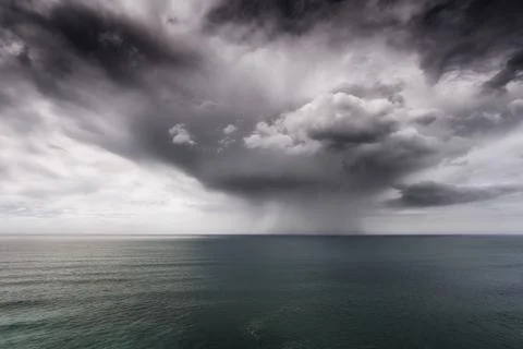 Rain and stormy cloud over sea Stock Photos