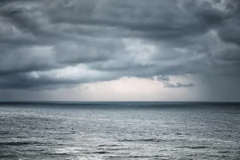 Rain and stormy cloud over sea Stock Photos