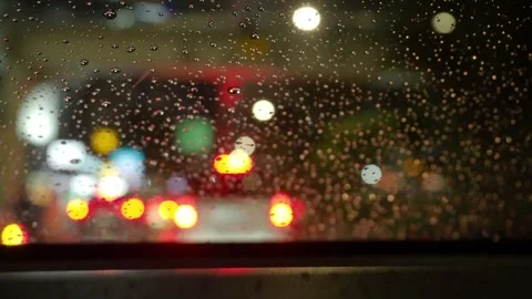 Rain and traffic jam. Raindrops on car windshield at night road. Stock Footage 344695794