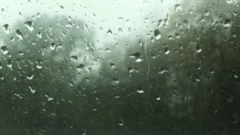Rain and traffic on a window blur background video Stock Footage 255152605