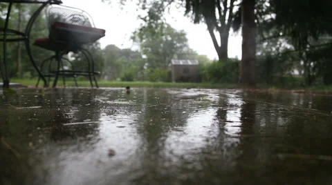 Rain on backyard patio Video stock 54800426