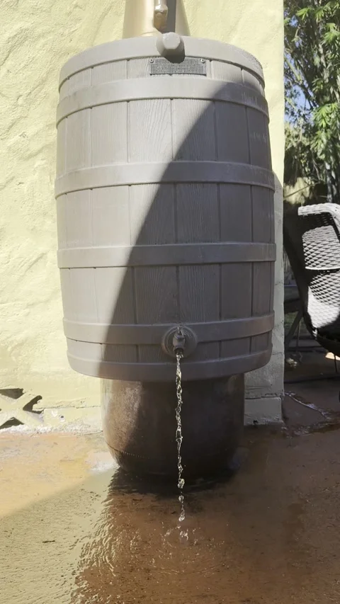 Rain Barrel on Florida Patio Spraying Water from Spigot Stock Footage 321142870