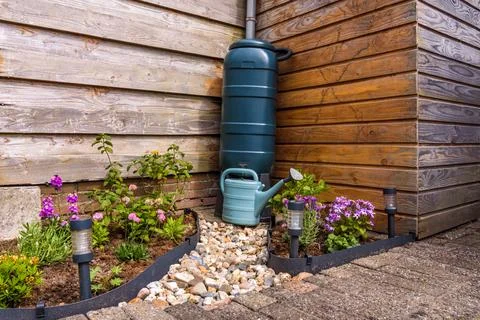 Rain barrel in garden Stock Photos
