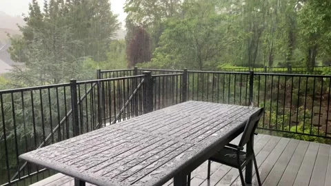Rain beating down on aluminum patio table and chair Vídeos de archivo 132602461