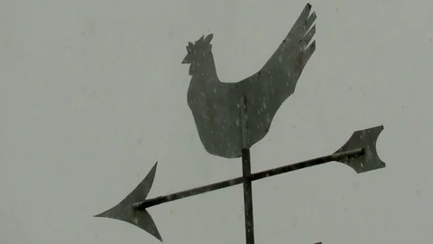 Rain beats onto a weather vane during a torrential thunderstorm. Video stock 75675301