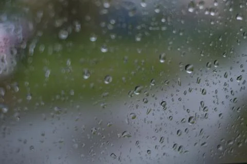 Rain behind a window. rain drops on glass. cars on the road. heavy rain Stock Photos