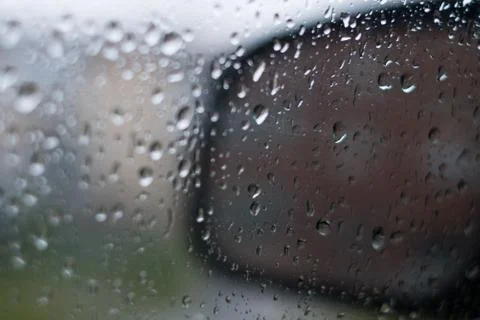 Rain behind a window. rain drops on glass. cars on the road. heavy rain Stock Photos