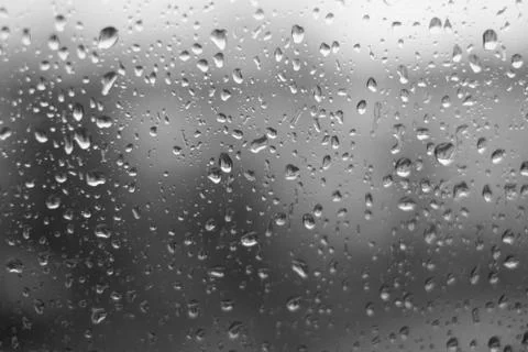 Rain behind a window. rain drops on glass. cars on the road. heavy rain Stock Photos