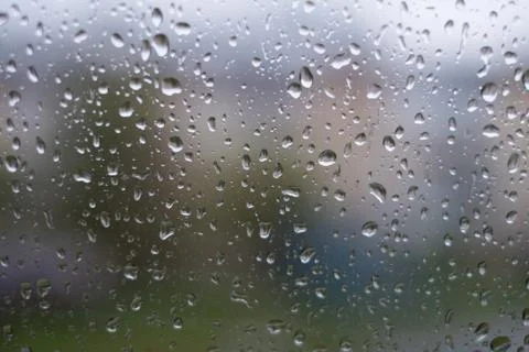 Rain behind a window. rain drops on glass. cars on the road. heavy rain Stock Photos