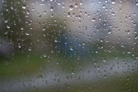 Rain behind a window. rain drops on glass. cars on the road. heavy rain Stock Photos