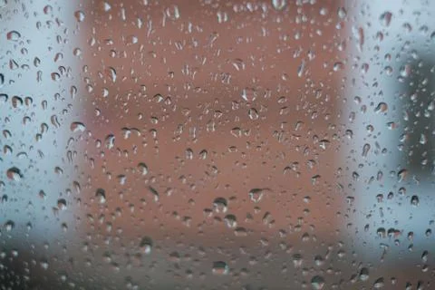 Rain behind a window. rain drops on glass. cars on the road. heavy rain 스톡 사진