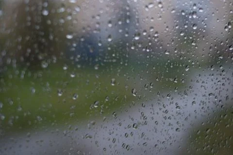 Rain behind a window. rain drops on glass. cars on the road. heavy rain 스톡 사진