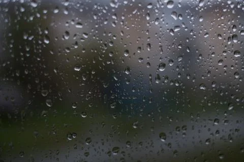 Rain behind a window. rain drops on glass. cars on the road. heavy rain 스톡 사진