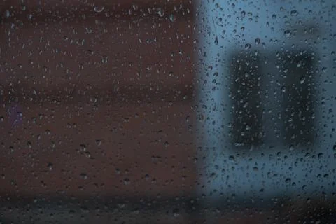 Rain behind a window. rain drops on glass. cars on the road. heavy rain Stock Photos