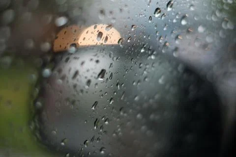 Rain behind a window. rain drops on glass. cars on the road. heavy rain 스톡 사진