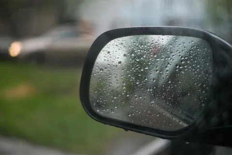 Rain behind a window. rain drops on glass. cars on the road. heavy rain 스톡 사진