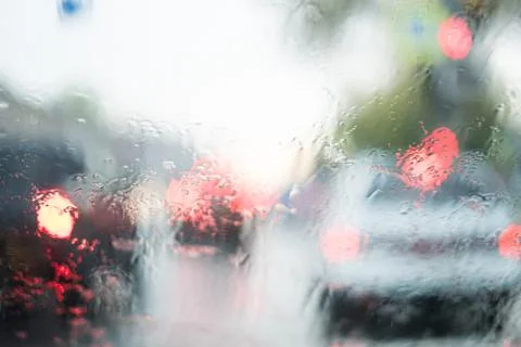 Rain behind a window. rain drops on glass. cars on the road. heavy rain 스톡 사진
