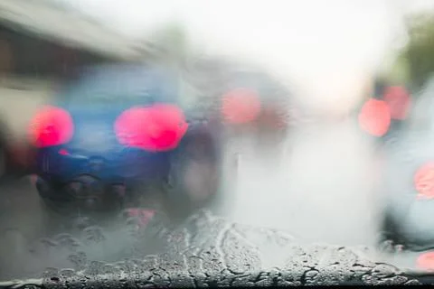 Rain behind a window. rain drops on glass. cars on the road. heavy rain Stock Photos
