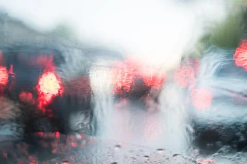 Rain behind a window. rain drops on glass. cars on the road. heavy rain Stock Photos