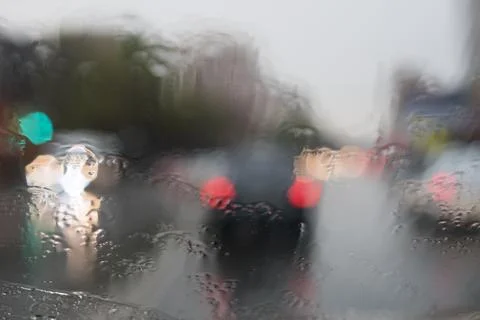 Rain behind a window. rain drops on glass. cars on the road. heavy rain Stock Photos