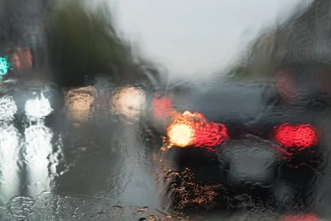 Rain behind a window. rain drops on glass. cars on the road. heavy rain 스톡 사진