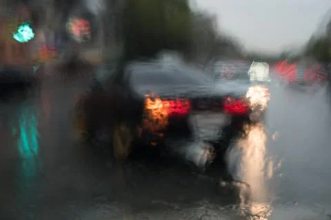 Rain behind a window. rain drops on glass. cars on the road. heavy rain 스톡 사진