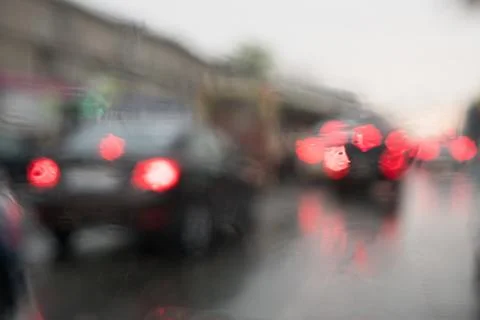 Rain behind a window. rain drops on glass. cars on the road. heavy rain 스톡 사진