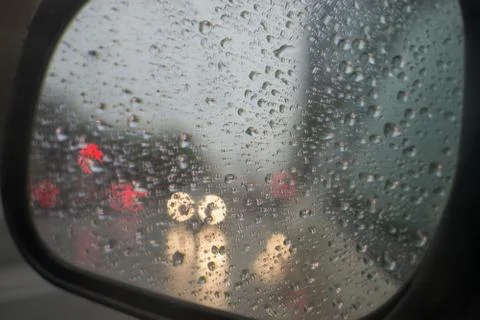 Rain behind a window. rain drops on glass. cars on the road. heavy rain 스톡 사진