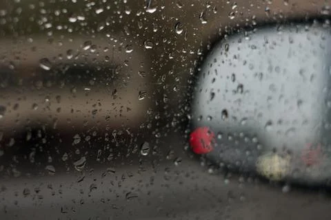 Rain behind a window. rain drops on glass. cars on the road. heavy rain 스톡 사진