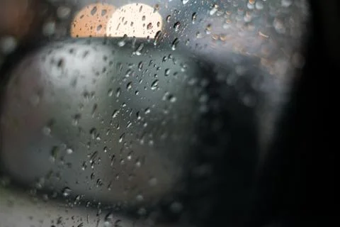 Rain behind a window. rain drops on glass. cars on the road. heavy rain Stock Photos