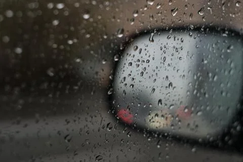 Rain behind a window. rain drops on glass. cars on the road. heavy rain 스톡 사진