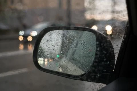 Rain behind a window. rain drops on glass. cars on the road. heavy rain Stock Photos