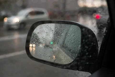 Rain behind a window. rain drops on glass. cars on the road. heavy rain Stock Photos
