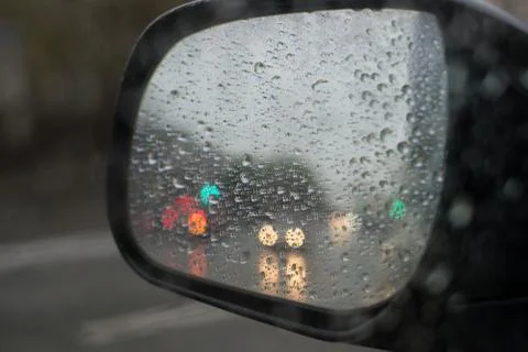Rain behind a window. rain drops on glass. cars on the road. heavy rain Stock Photos