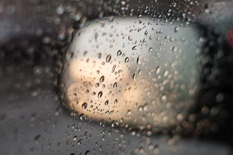 Rain behind a window. rain drops on glass. cars on the road. heavy rain Stock Photos