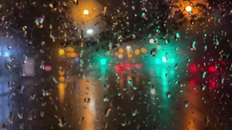 Rain bokeh road lights. Abstract shot of evening city traffic bokeh Stock Footage 253388201