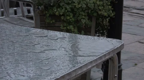 Rain on a cafe table HD Stock Footage 7631414