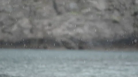 Rain On Calm Sea With Rocks In Background Video stock 61584237