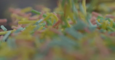 Rain candies fall onto the mirror surface Stock Footage 197426650