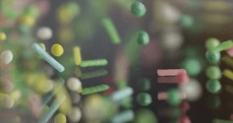 Rain candies fall from the side onto the mirror surface Stock Footage 200254982