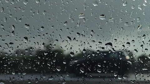 Rain on car window with blurred highway traffic during stormy weather Stock Footage 345546293