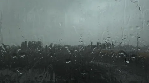 Rain on a car window looking towards rail line in England UK 4K Video stock 143096420