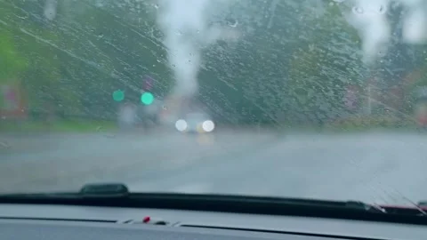 Rain on Car Windshield with Wipers Moving in Slow Motion During Drive Stock Footage 324841119
