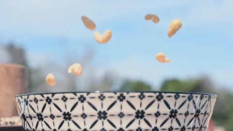 Rain of cashews falling into a bowl- slow motion 動画素材 107683880