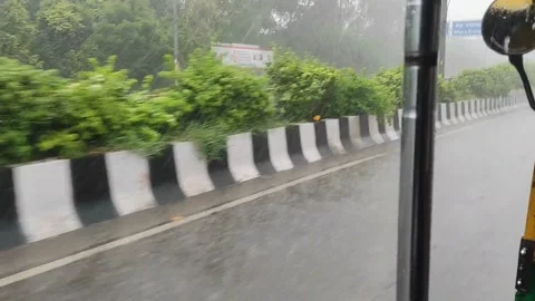 Rain causes waterlogging in many areas of New Delhi, India, traffic movement Stock Footage 170475905