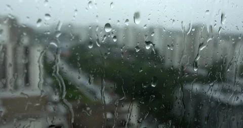 Rain in city, closeup on raindrops on window Vídeo Stock 154848939
