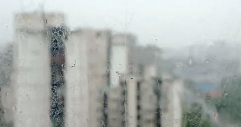 Rain in city, closeup on raindrops on window Stock Footage 241566177