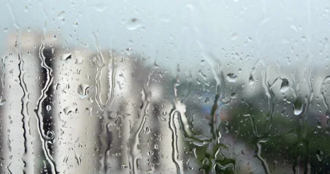 Rain in city, closeup on raindrops on window Stock Footage 241567183