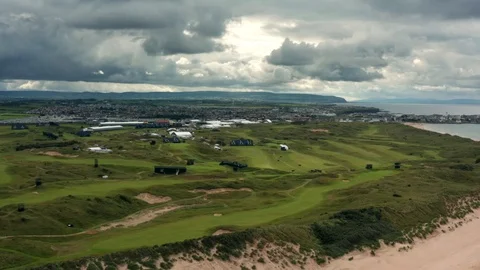 Rain cloud aerial view of Portrush beach, town and golf course, Northern Ireland Stock Footage 112657410
